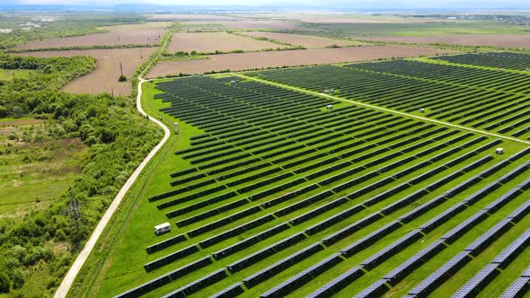Aerial View of Big Sustainable Electric Power Plant with Many Rows of Solar Photovoltaic Panels for