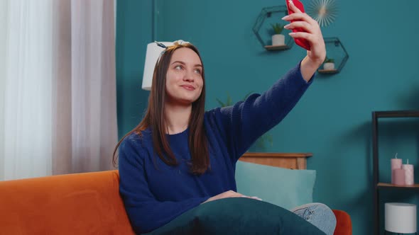Woman on Sofa at Home with Smartphone Taking Selfie on Mobile Phone Cam Virtual Video Call Online