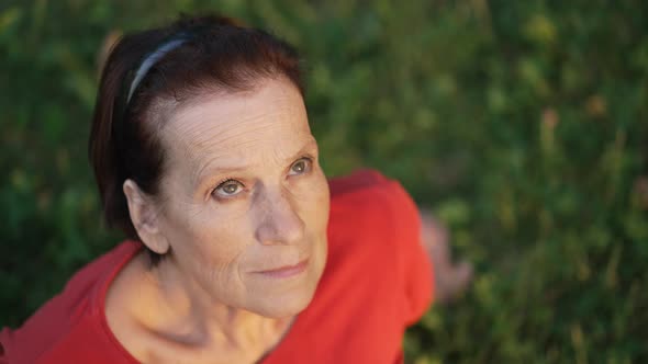 Elderly Woman Looks to the Sky