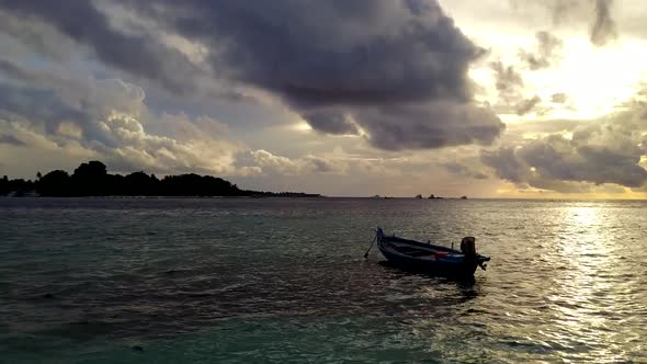 Aerial drone panorama of island beach time by blue lagoon with sand background