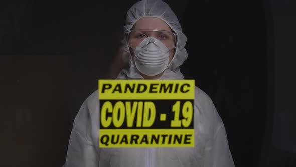 Woman in Protective Suit in Quarantine Zone Signed Stop. Coronovirus and Isolation Concept