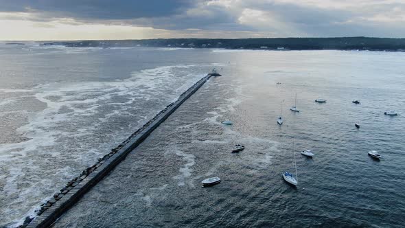 Aerial View Of Eastern Point Lighthouse At The Pier In Gloucester, Massachusetts With Sailboats Adri