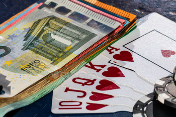 Stacks of poker chips with money and cards