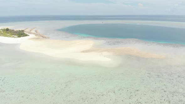 Aerial: Flying over idyllic atoll, Wakatobi Marine National Park Indonesia