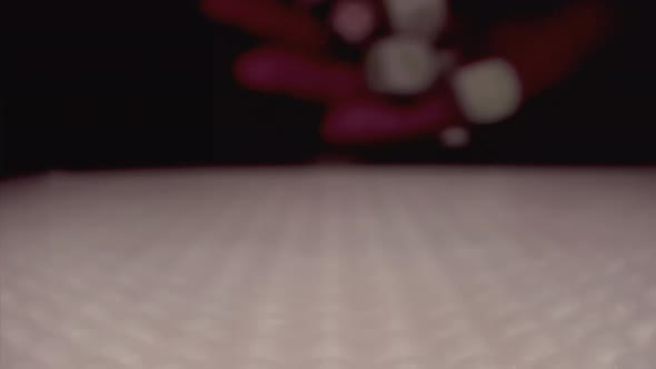 The Slow Motion of Rolling Gaming Dices on Light White Poker Table