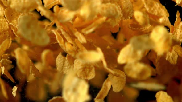 Super Slow Motion Cornflakes Take Off Against a Black Background