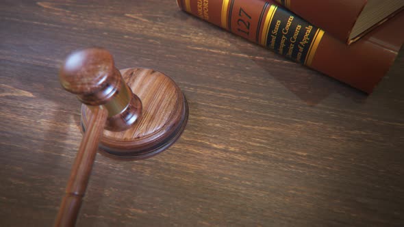 Hardwood gavel hitting sound block in court of law. Symbol of justice, judgement