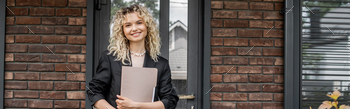 blonde woman standing with folder near new city building, successful real estate agent, banner