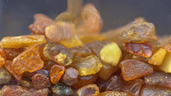 Raw Amber Stones Falling Down Slow Motion Close-up