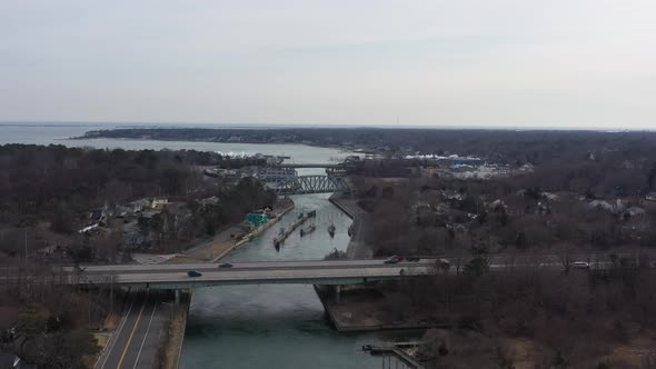 An aerial view over the Shinnecock Canal in Hampton Bays, Long Island, NY. The drone camera dolly in