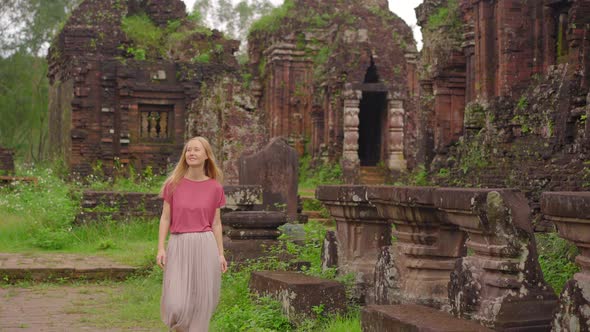 A Young Woman Tourist Is Walking Through Ruins in the My Son Sanctuary Remains of an Ancient Cham