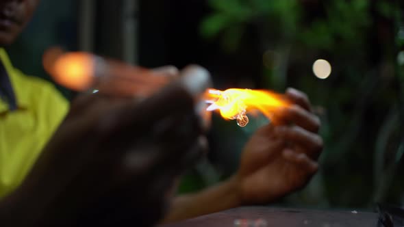 Senior man forming melted glass