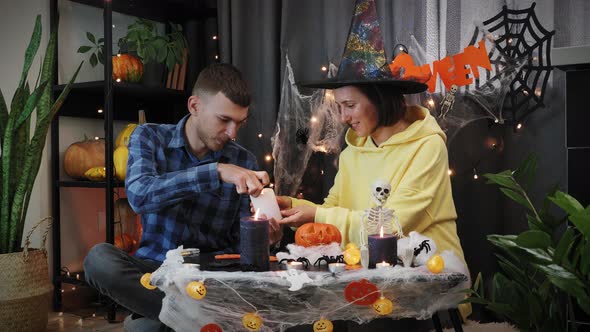 Happy Halloween. Trick or treat. Couple lighting candles for Halloween