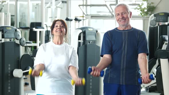 Couple of Seniors Training at Gym