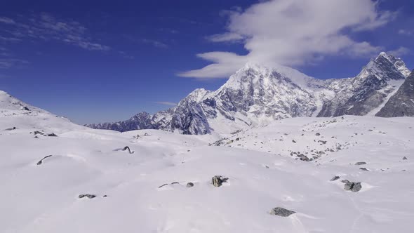 Flying over snow covered landscape in the Himalayas near Manang Nepal