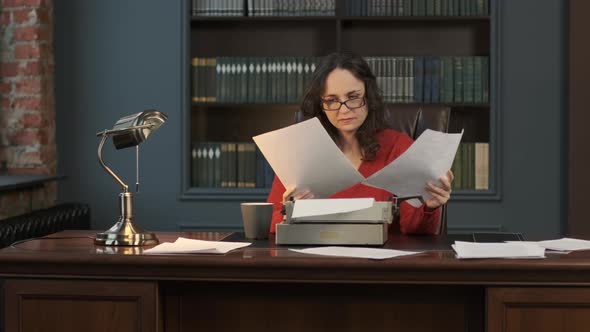 Focused Woman Writing an Article or Novel Indoors