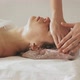 A Masseur Gives a Woman a Professional Facial Massage - VideoHive Item for Sale