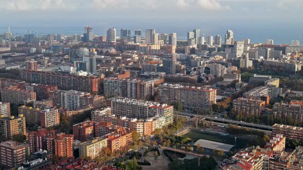 Aerial drone view of Barcelona, Spain. Multiple residential and office buildings, Mediterranean sea 