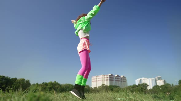 Wide Shot Joyful Woman in Retro Clothes Jumping Spinning Dancing Outdoors in Sunshine