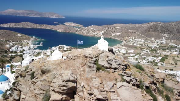 Aerial view from top of Chora village. Greek flag, sea and town view