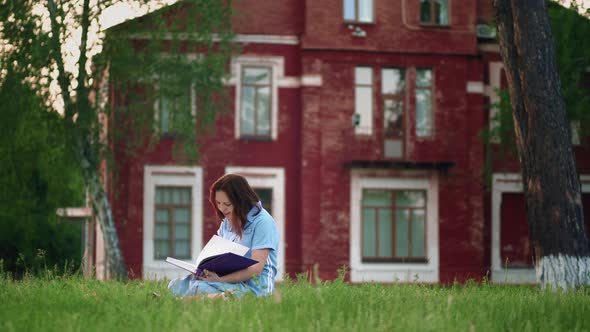 Woman Reading a Book in the Park