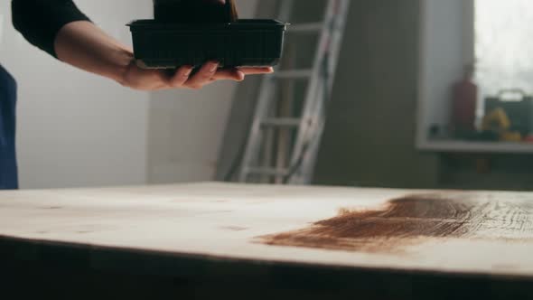 Woman Builder Varnishing Wooden Table Closeup