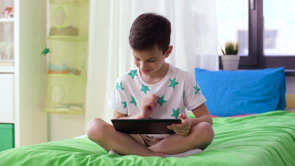 Smiling Boy with Tablet Pc Computer at Home