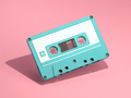 Blue vintage audio cassette on pink background. - PhotoDune Item for Sale