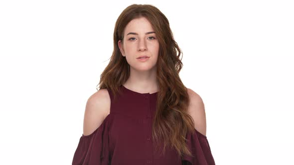 Portrait of Calm Young Woman with Long Brown Hair Posing at Camera with Confident Look Isolated Over