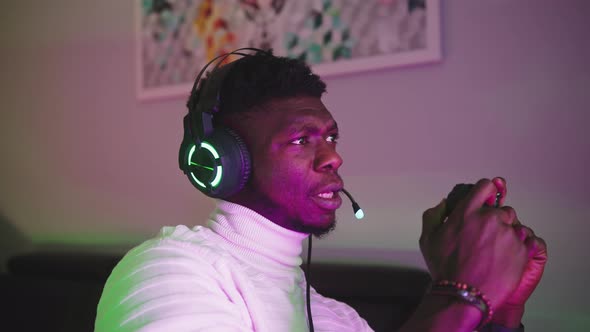 Portrait of Happy Black Man Playing Game Using Video Game Console Controlling Joystick