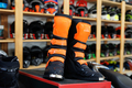 Motorcycle equipment in the form of boots in a motorcycle shop. - PhotoDune Item for Sale