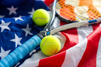 ith yellow tennis balls, red racket and the flag of America on a green background. US open. Flat lay. High quality photo