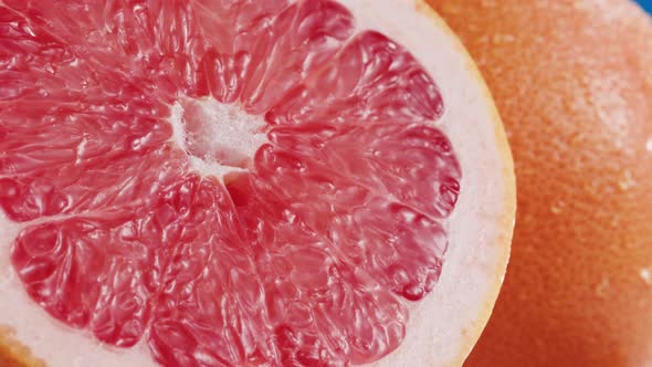 Grapefruits Isolated on Blue Background Pouring Water on Fresh and Ripe Citrus Fruits