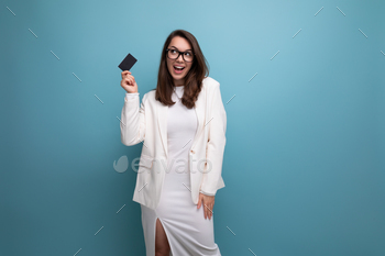 portrait of successful young business woman proudly standing with money card with salary