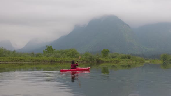 Adventure Caucasian Adult Woman Kayaking in Red Kayak