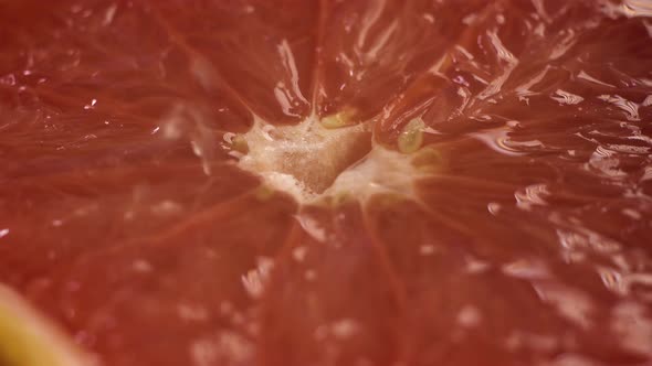 Close Up Macro Shot of Grapefruit, Which Is Crushed or Squeezed. Fruit Juice Covers Go Out and Cover