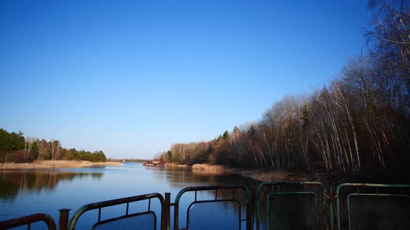 Pripyat Blue River behind rusted metal gate, Chernobyl