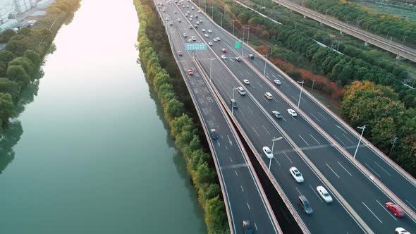 Aerial View of Highway and Overpass with Cars and Trucks at Sunset