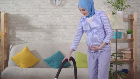 Portrait Young Muslim Pregnant Woman Doing Homework and Vacuuming