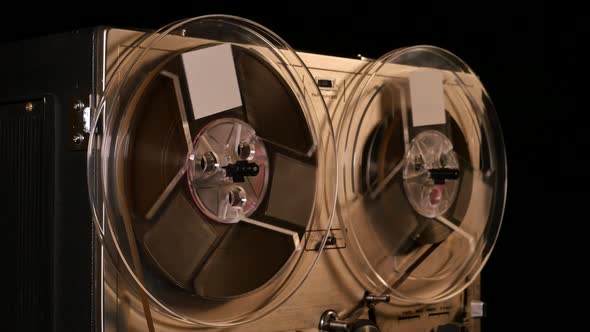 Vintage Reel to Reel tape recorder playing music close up of reel