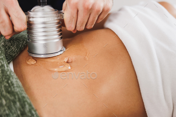 tation treatment to fat reduction on abdomen at the beauty salon.