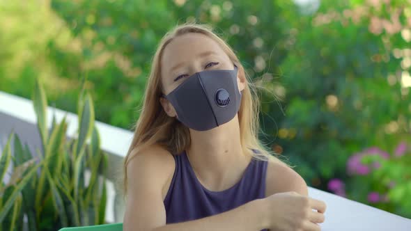 Young Woman in a Tissue Face Mask Looks at the Camera. Fashionable Face Masks. Social Distancing