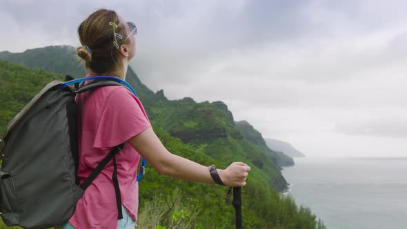 Happy Tourist with Backpack and Hiking Sticks Freedom Hawaii Travel Concept