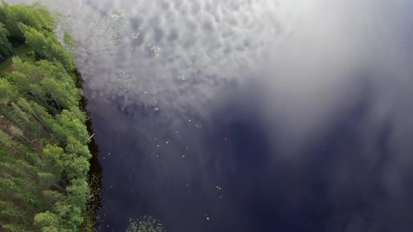 Mesmerizing aerial footage of sky reflecting on a surface of a lake. Borealis wilderness.