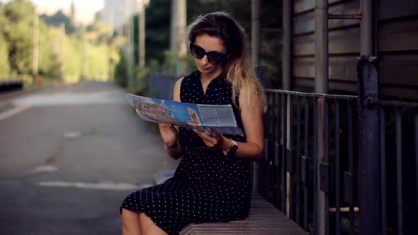 Female Traveler Waiting Train And Looking Town Plan On Navigation Map For Journey.