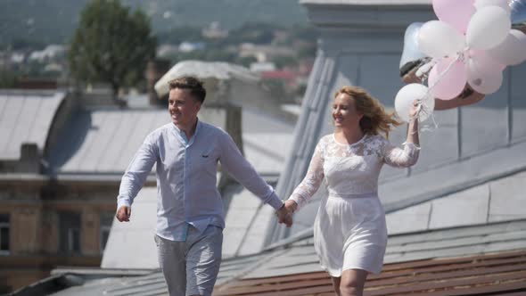 Couple walking with balloons alt