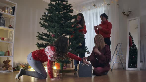 Living Room with Christmas Tree and Four Women Decorating on New Year's Eve