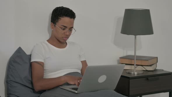 African Woman Showing Thumbs Up Sign While Using Laptop in Bed