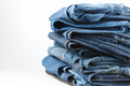Denim jeans stacked on a white background. Trend clothes, shopping. - PhotoDune Item for Sale