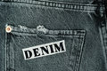 Back of black jeans, pocket with embroidered DENIM lettering, - PhotoDune Item for Sale